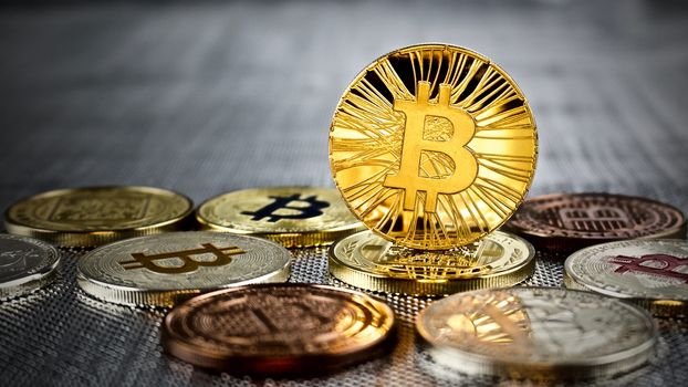 Cryptocurrency physical gold bitcoin coin on bitcoins. Money concept.