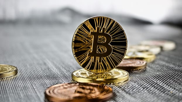 Cryptocurrency physical black bitcoin coin and other coins. Money concept.