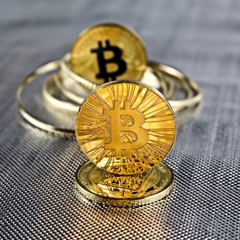 Digital currency physical gold bitcoin coins. Silver background concept.