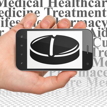 Medicine concept: Hand Holding Smartphone with  black Pill icon on display,  Tag Cloud background, 3D rendering