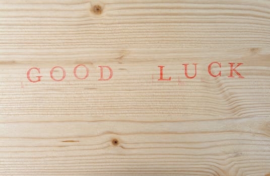 Stamped text Good luck on wood, background