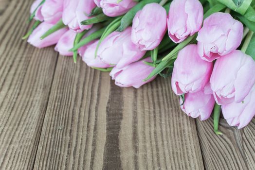 Bouquet of tulip flowers on the background of old wooden boards