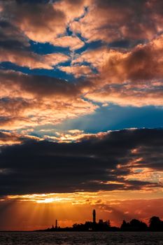 Golden sunset sky over the town silhouette