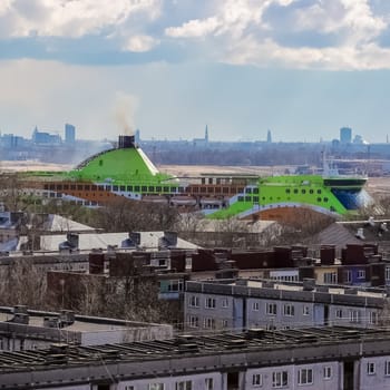 Green cruise liner. Passenger ferry sailing past the Riga city