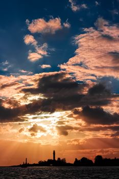 Golden sunset sky over the town silhouette