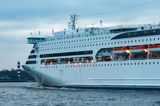 White cruise liner. Passenger ferry moving in still water