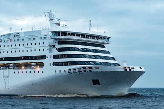 White cruise liner. Passenger ferry moving in still water