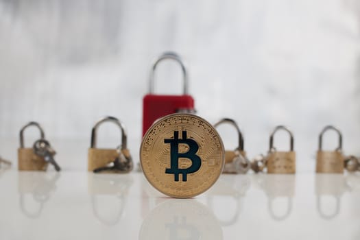 Cryptocurrency physical gold bitcoin coin. Gold padlocks concept.