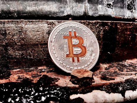Cryptocurrency physical silver bitcoin coin in old industry.