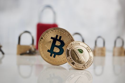 Digital currency physical gold bitcoin coin and gold peercoin coin.