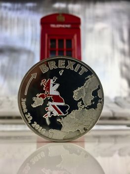 Physical silver brexit coin with a british flag. Europe leaving.