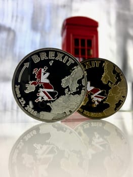 Physical silver and gold brexit coins on the table. Europe leaving.