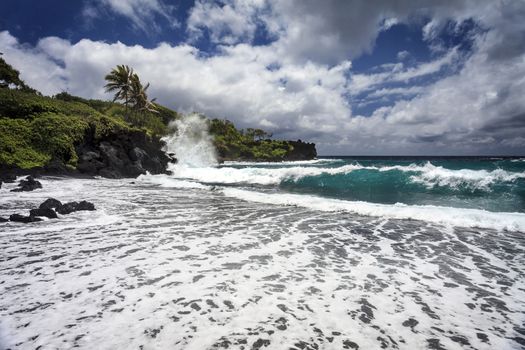 This is an image of Waianapanapa State Park, located in Hana on the island of Maui, Hawaii. Below is one of the parks most beautiful beaches.