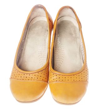 Comfortable orange leather flat shoes isolated on white