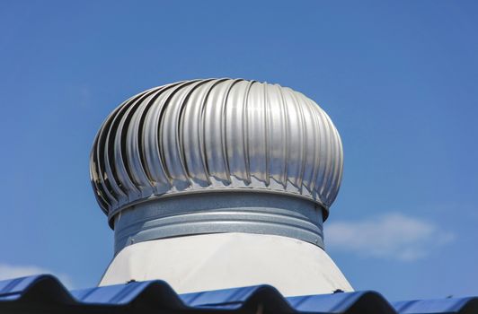 stainless steel exhaust fan on roof with blue sky