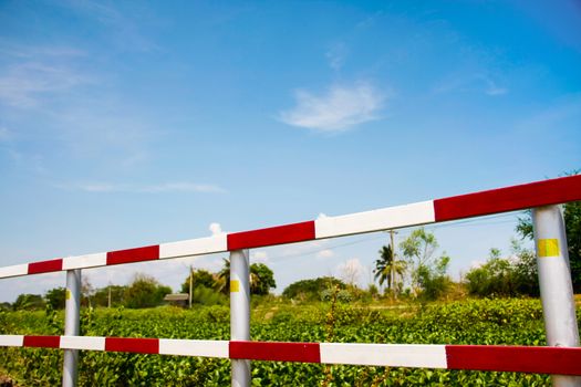 dangerous traffic fence beside street and canal for safety with blue sky