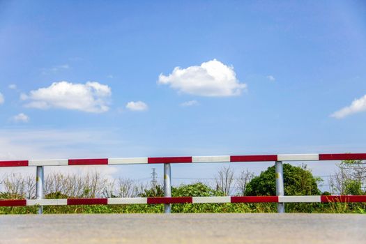 dangerous traffic fence beside street with blue sky for safety