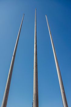 tree flagpole vertical up to blue sky in Stadium