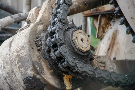 old chain with grease on propel roller for motor powered