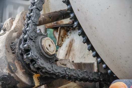 old chain with grease on propel roller for motor powered