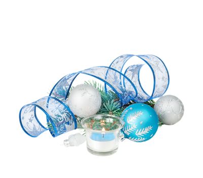 Beautiful Christmas card with burning candle, blue and silver Christmas balls, blue ribbon and fir branches, isolated on a white background