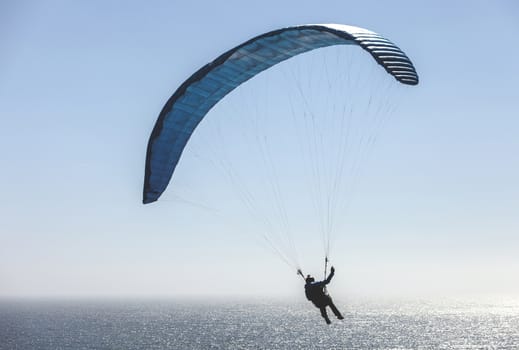 This is an image of a paraglider over Muscle Beach along California’s central coast.  Muscle beach is located in Pacifica, California, which is a prime spot for paragliding due to its fantastic weather conditions and views. 