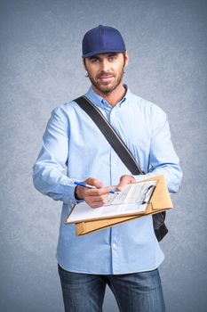 Handsome young delivery man holding document folder ask to sign invoice