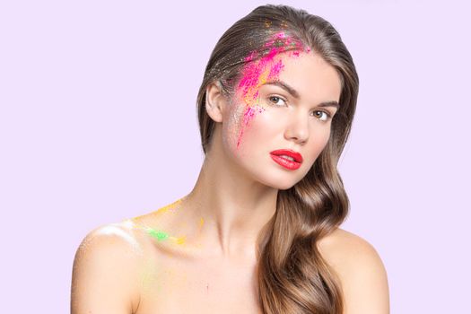 Beauty portait of woman with many color glitters over natural makeup