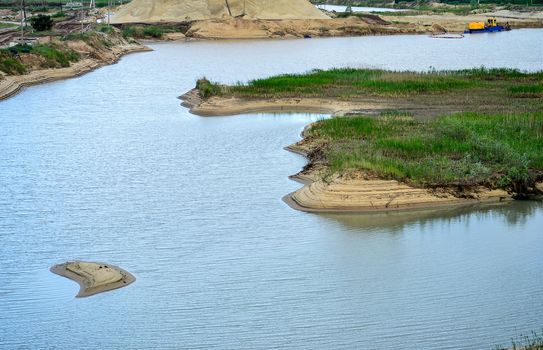 Extraction of sand, sand pit with water.