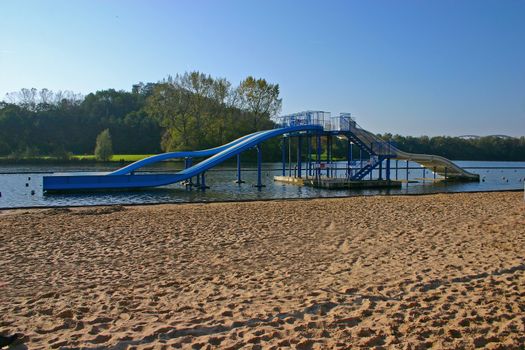 Blue Swimming sledges in a lake close to the beach