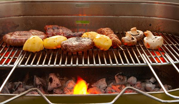 Cooking tastetful meat on a barbecue outside in the garden