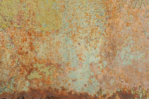 fragment of a rusty iron surface covered with old paint, which has long been under the influence of different climatic conditions