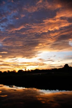 orange sky reflect on canal in evening