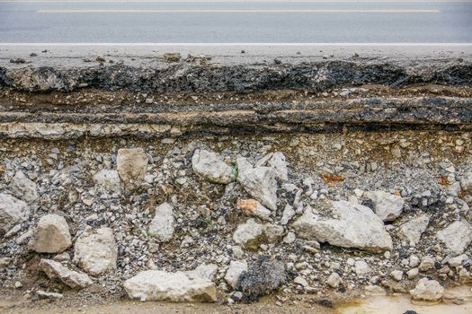 broken asphalt layer road with water