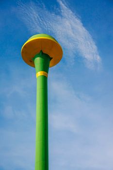 green public water tank hold up to blue sky