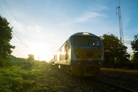 Old Train on Railway Track in morning sunshine with Rural Scene