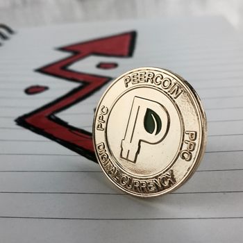 Digital currency physical gold peercoin coin and red arrow in notebook.