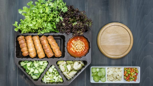top view of roasted pork served with spicy sauce and vegetable (Nam Neung) on wooden background