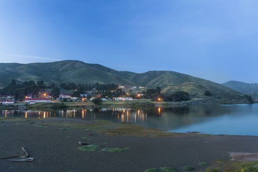 This image was taken at Rodeo Beach located in the Marin Headlands located near Sausalito, Ca. This image was captured just as the lights in the old military building were beginning to come on.