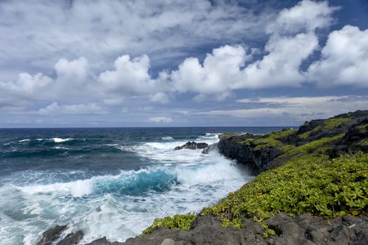 This is an image of Waianapanapa State Park, located in Hana on the island of Maui, Hawaii. Below is one of the parks most exciting areas due to its rocky and rugged cliffs.