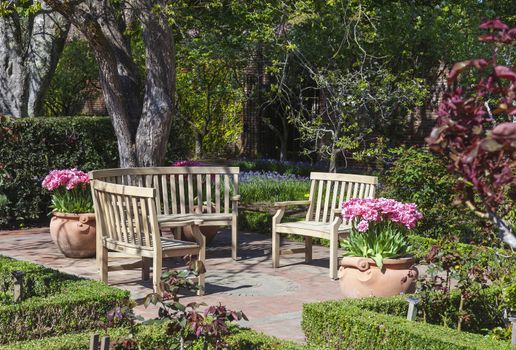 This circular set of benches is located in a formal botanical garden. The garden featured freshly blooming tulips which can be found throughout the park.