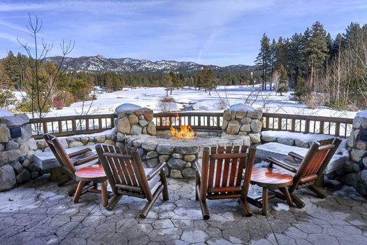 Chairs and fire pit overlooking the Edgewood GC on a winter day in Lake Tahoe, Nevada. 