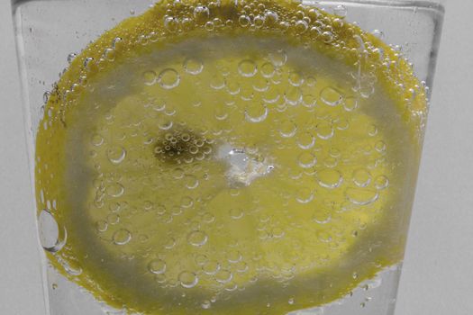 Lemon Slice In Water With Air Bubbles