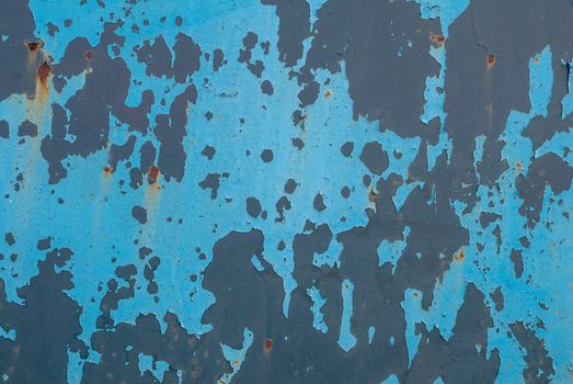 fragment of an iron surface is covered with blue color paint, which has long been under the influence of different climatic conditions