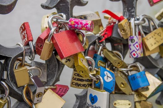 Locks and Keys on Charles Bridge in Prague, blank red lock in focus