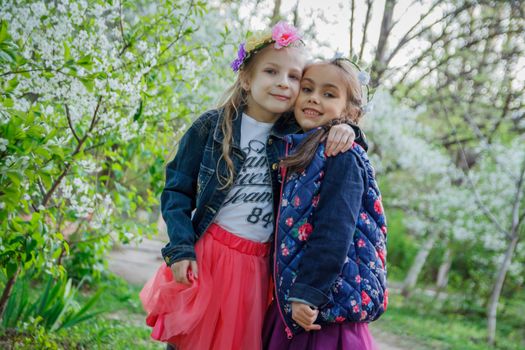 Two happy girls enjoying spring garden