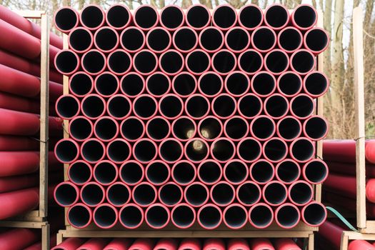 Stockyard of various tubes and pipes at a construction site.