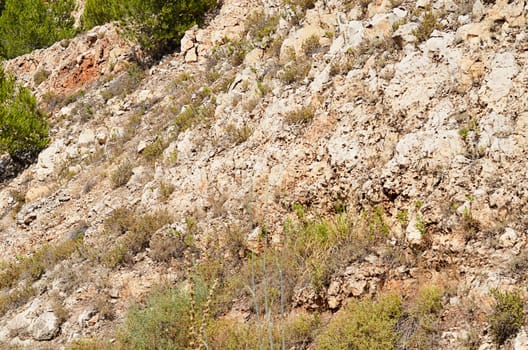 Stone rock near the road close up