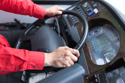 Hand close up of couch driver driving passenger bus