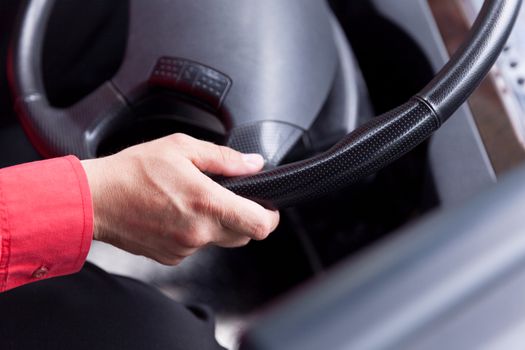 Hand close up of bus driver driving passenger bus